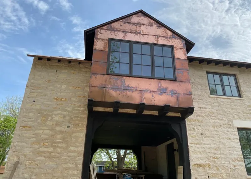 Copper metal panel facade on a stone building for Roof Repair in Plumsted
